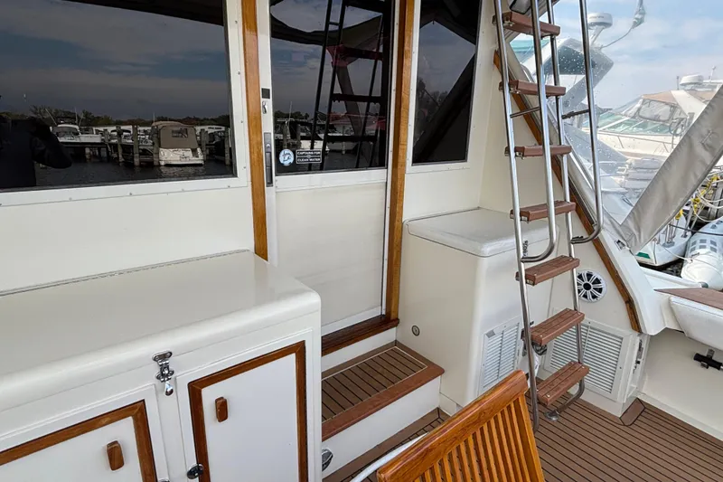 Slide: The Image of 1986 Viking 48 Convertible yacht interior with wooden accents and ladder. - 17