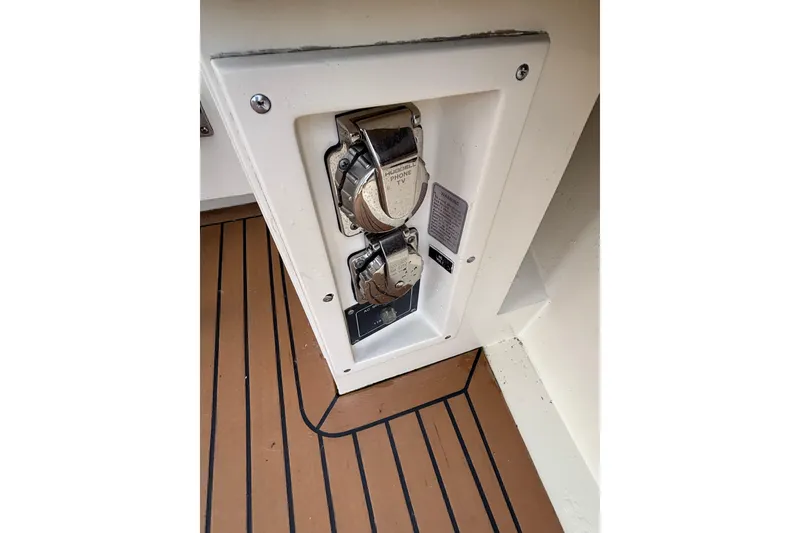 Slide: The Image of Power outlet panel on 1986 Viking 48 Convertible boat with teak flooring. - 19