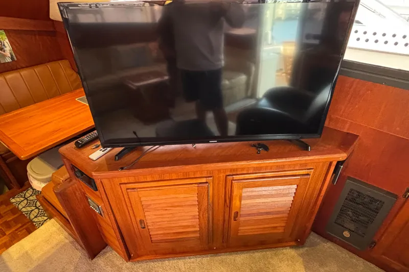 Slide: The Image of Interior of 1986 Viking 48 Convertible with TV on wooden cabinet. - 23