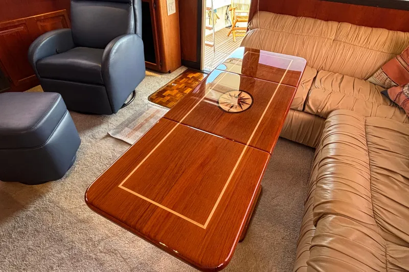 Slide: The Image of Luxurious interior of 1986 Viking 48 Convertible yacht with elegant wood table and plush seating. - 26
