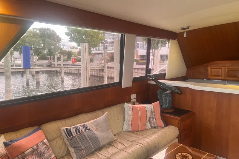 Slide: The Image of Interior of 1986 Viking 48 Convertible yacht with cozy seating and waterfront view. - 27