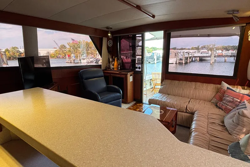 Slide: The Image of Interior of 1986 Viking 48 Convertible yacht with cozy seating and marina view. - 35