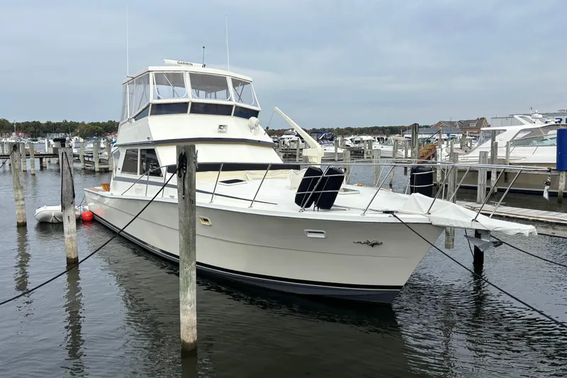 Slide: The Image of 1986 Viking 48 Convertible yacht docked at marina, overcast sky. - 4