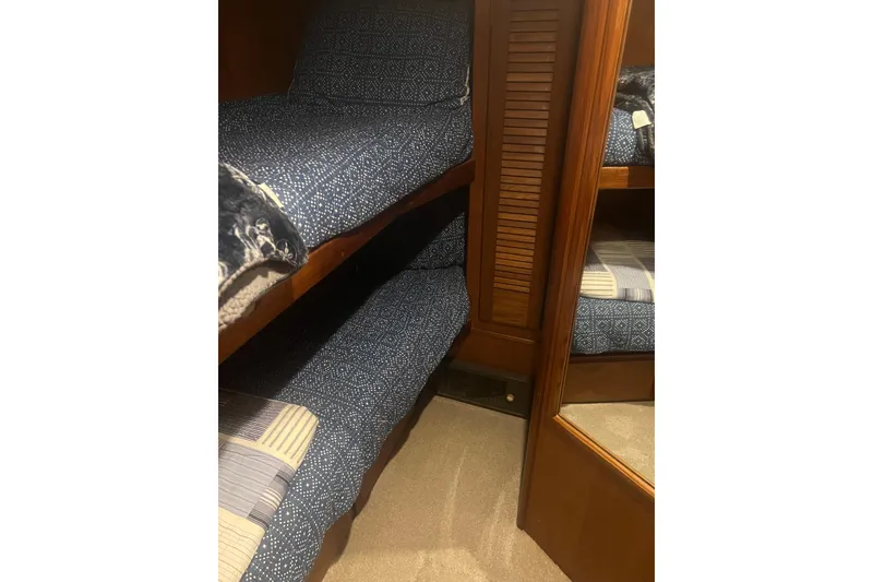 Slide: The Image of Bunk beds with blue patterned bedding in 1986 Viking 48 Convertible yacht cabin. - 40