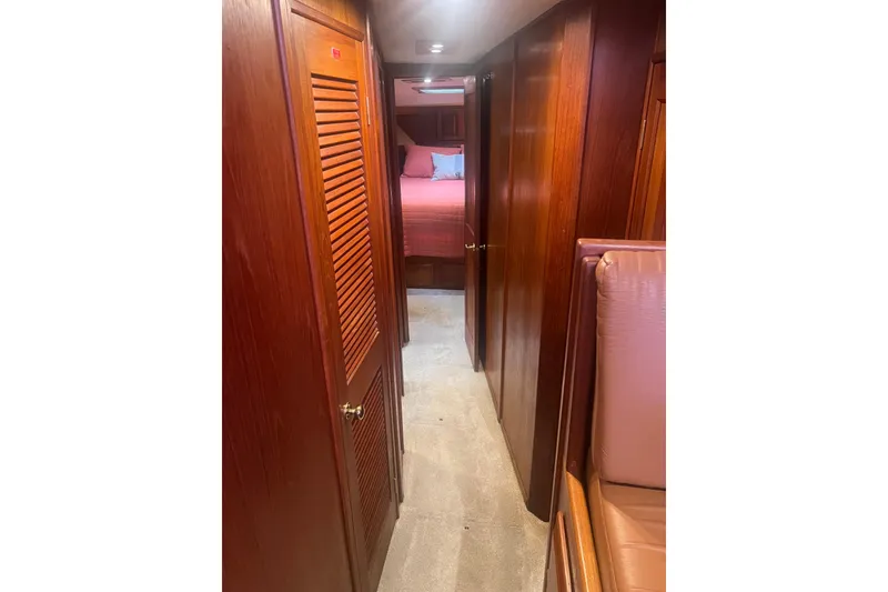 Slide: The Image of Interior hallway of 1986 Viking 48 Convertible yacht with wooden paneling and carpet. - 43