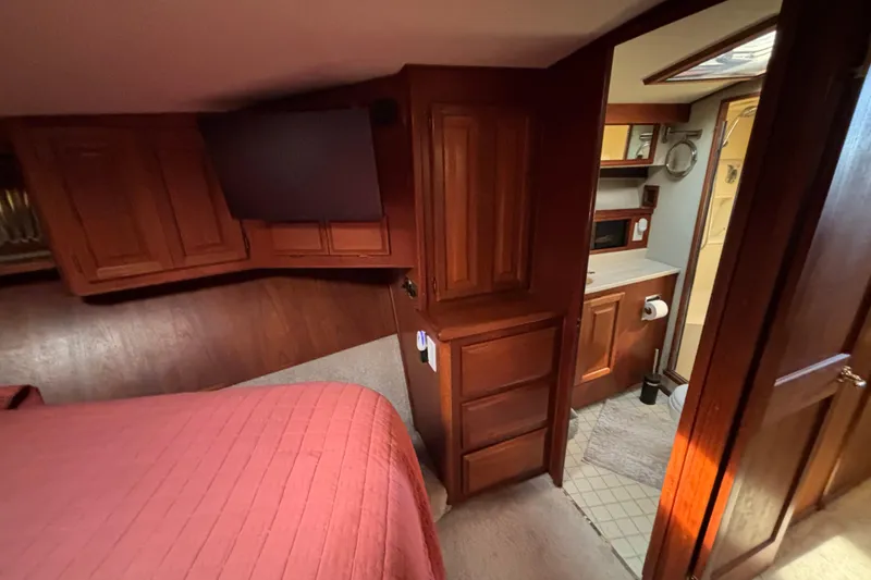 Slide: The Image of 1986 Viking 48 Convertible yacht interior with wood cabinetry and cozy bedroom. - 47