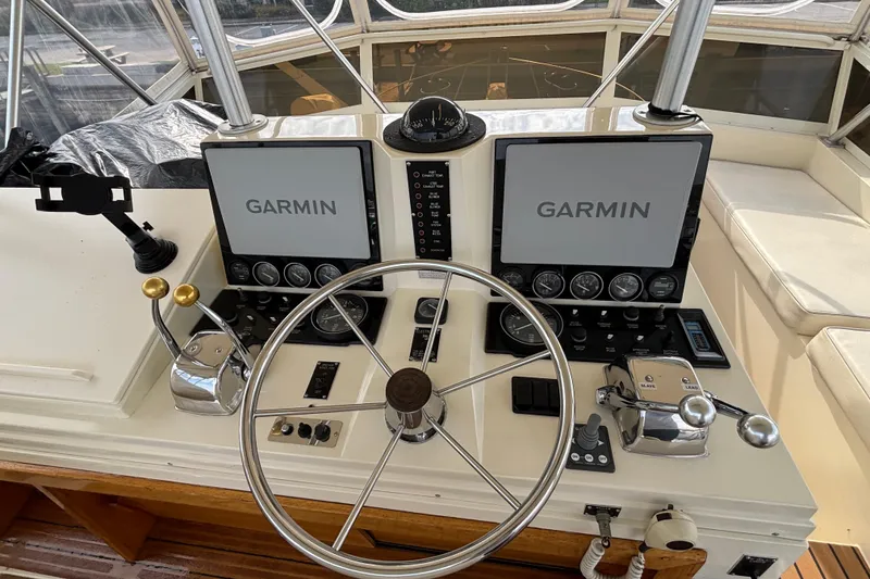 Slide: The Image of Control panel of a 1986 Viking 48 Convertible boat with Garmin navigation displays. - 52