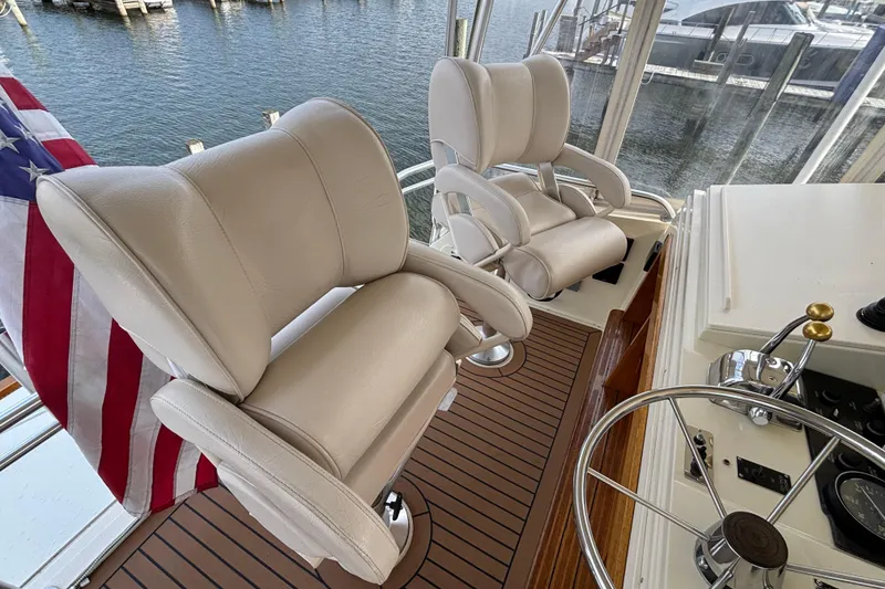 Slide: The Image of Luxury helm seating on 1986 Viking 48 Convertible yacht with American flag. - 53