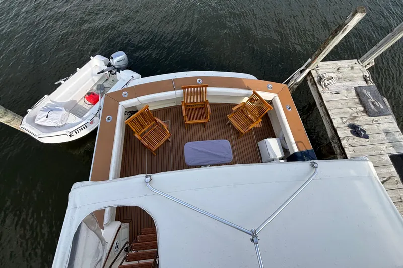 Slide: The Image of Aerial view of 1986 Viking 48 Convertible yacht deck with chairs and docked boat. - 58