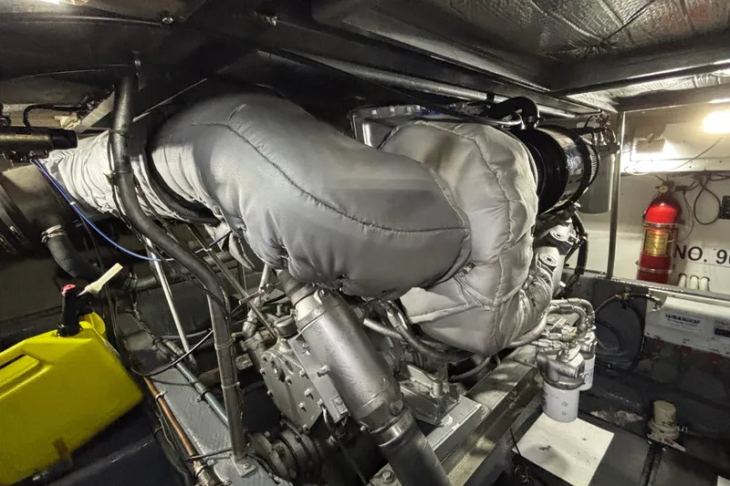 Slide: The Image of Engine room of 1986 Viking 48 Convertible yacht with insulated components and fire extinguisher. - 62