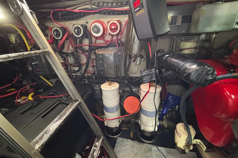Slide: The Image of Engine room of a 1986 Viking 48 Convertible with wiring and filters visible. - 66