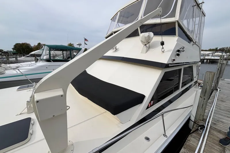 Slide: The Image of 1986 Viking 48 Convertible yacht docked at marina, featuring sleek design and spacious deck. - 7