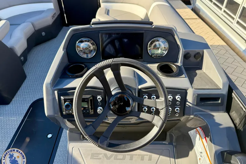 Slide: The Image of Steering console of 2026 Evotti 523CS boat with modern controls and seating. - 11