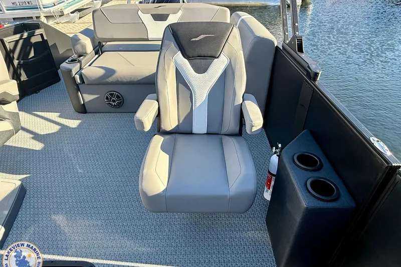 Slide: The Image of 2026 Evotti 523CS boat interior with gray seating, cup holders, and water view. - 13