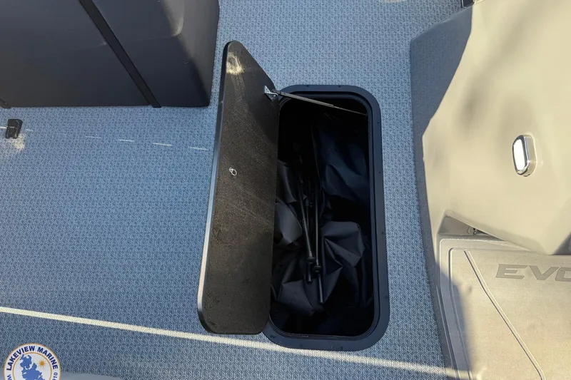 Slide: The Image of Open storage compartment on 2026 Evotti 523CS boat with textured flooring. - 14