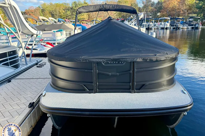 Slide: The Image of Covered Evotti 523CS pontoon boat docked, surrounded by other boats, autumn trees in background. - 20