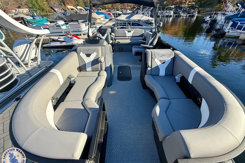 Slide: The Image of Luxurious 2026 Evotti 523CS pontoon boat with spacious seating at a marina. - 5