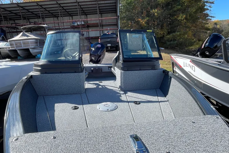 Slide: The Image of 2026 Lund 1775 Adventure Sport boat with dual windshields, parked outdoors. - 4