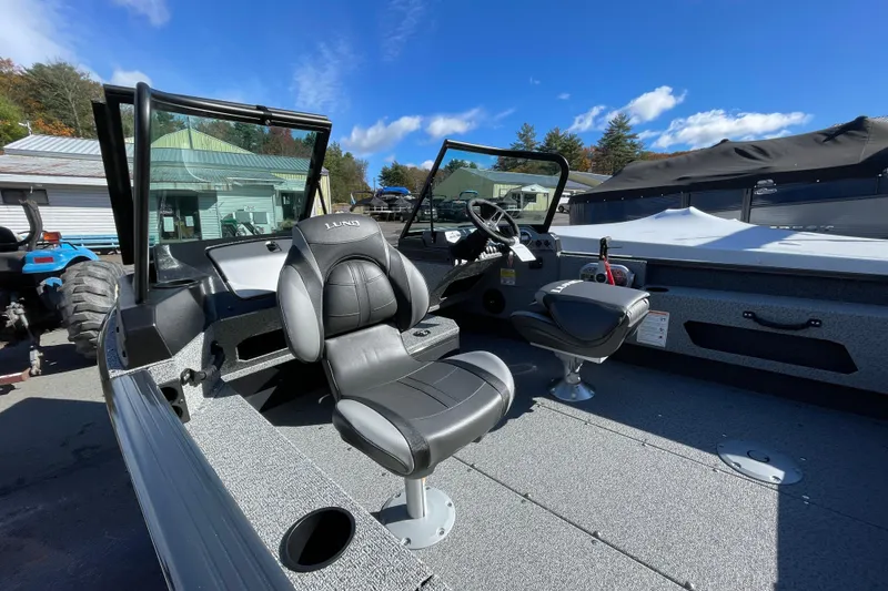 Slide: The Image of 2026 Lund 1775 Adventure Sport boat interior with black seats and steering wheel. - 5