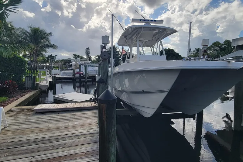 The Image of 2022 Twin Vee 260 CC SE Classic boat docked at a marina under cloudy skies. - 0