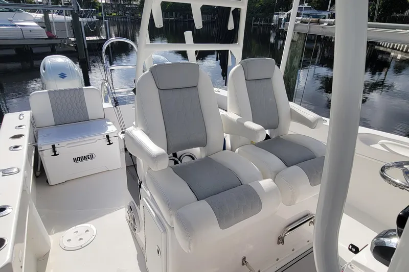 Slide: The Image of 2022 Twin Vee 260 CC SE Classic boat interior with plush seating and fishing gear. - 10