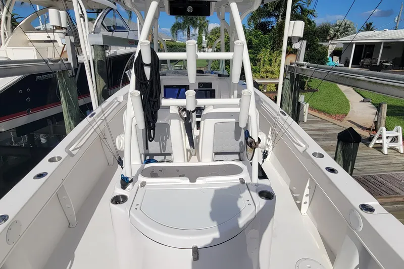 Slide: The Image of 2022 Twin Vee 260 CC SE Classic boat interior with fishing rod holders and seating. - 12
