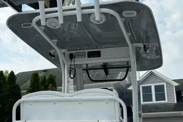 Slide: The Image of 2018 Sea Hunt Gamefish 27 boat with T-top and console, docked near residential area. - 13