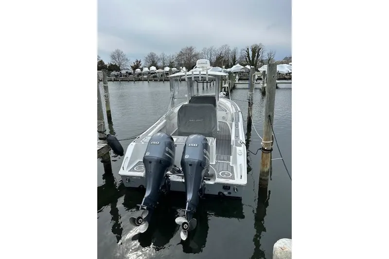Slide: The Image of 2018 Sea Hunt Gamefish 27 boat docked with dual outboard engines. - 18