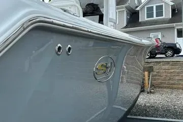 Slide: The Image of 2018 Sea Hunt Gamefish 27 boat docked near a residential area. - 2