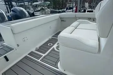 Slide: The Image of 2018 Sea Hunt Gamefish 27 boat interior with white seating and gray flooring. - 5