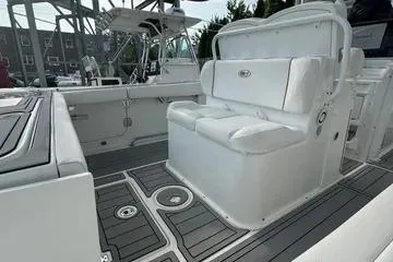 Slide: The Image of 2018 Sea Hunt Gamefish 27 boat interior with cushioned seating and sleek design. - 7