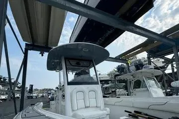 Slide: The Image of 2018 Sea Hunt Gamefish 27 boat in marina storage, under metal racks. - 9