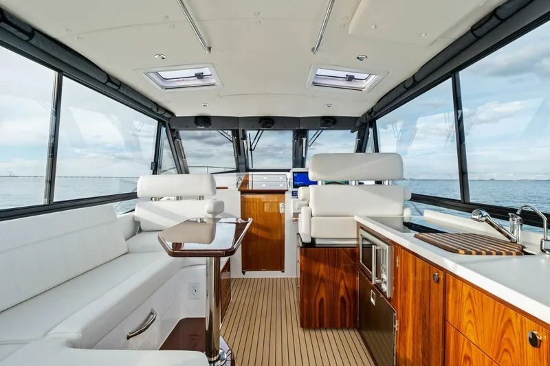 Slide: The Image of Luxurious interior of 2025 MJM 42 yacht with white seating and wooden accents. - 15