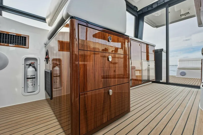 Slide: The Image of 2025 MJM 42 boat cruising on open water, showcasing sleek design and modern features. - 34