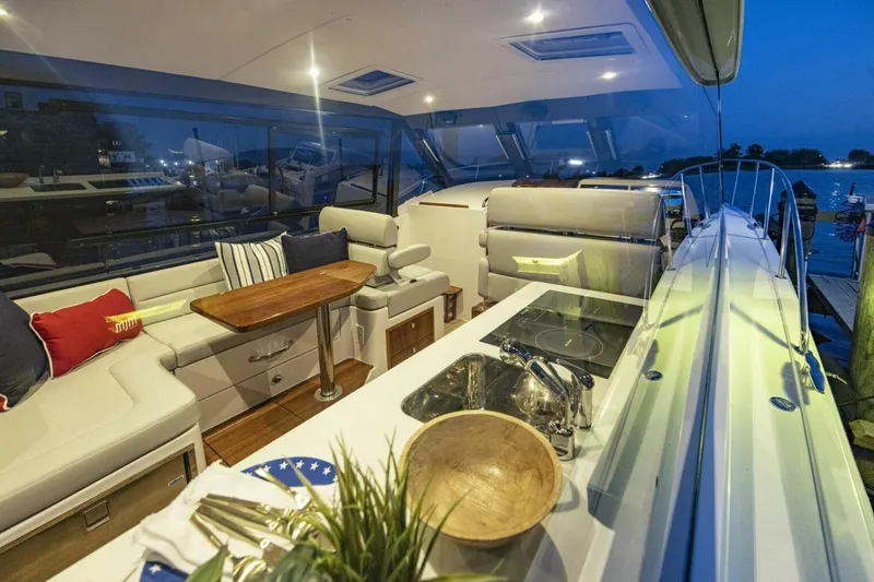 Slide: The Image of Luxury MJM 42 boat interior, 2025 model, with spacious seating and scenic ocean view. - 4