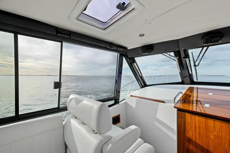 Slide: The Image of 2025 MJM 42 boat cruising on open water under a clear sky. - 40