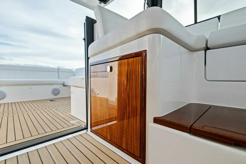 Slide: The Image of 2025 MJM 42 boat cruising on open water under a cloudy sky. - 43