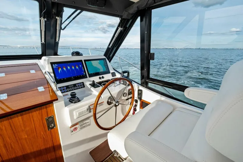 Slide: The Image of Luxurious interior of 2025 MJM 42 yacht with white seating and wooden accents. - 9