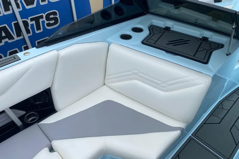 Slide: The Image of 2026 ATX Surf Boats 24 Type-S interior with white and gray seating, cup holders, and storage. - 8