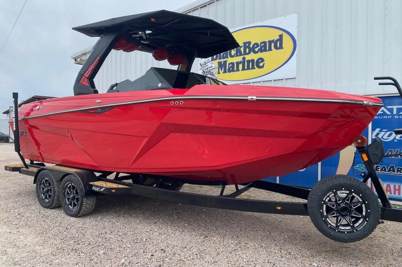 Slide: The Image of 2026 Tigé Z3 boat in vibrant red on a trailer at BlackBeard Marine. - 1