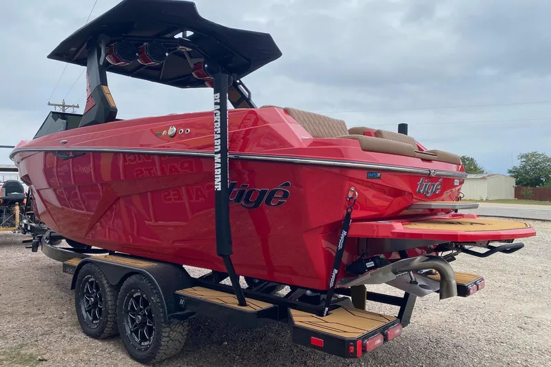 Slide: The Image of 2026 Tigé Z3 boat in vibrant red on a trailer, showcasing sleek design and modern features. - 3