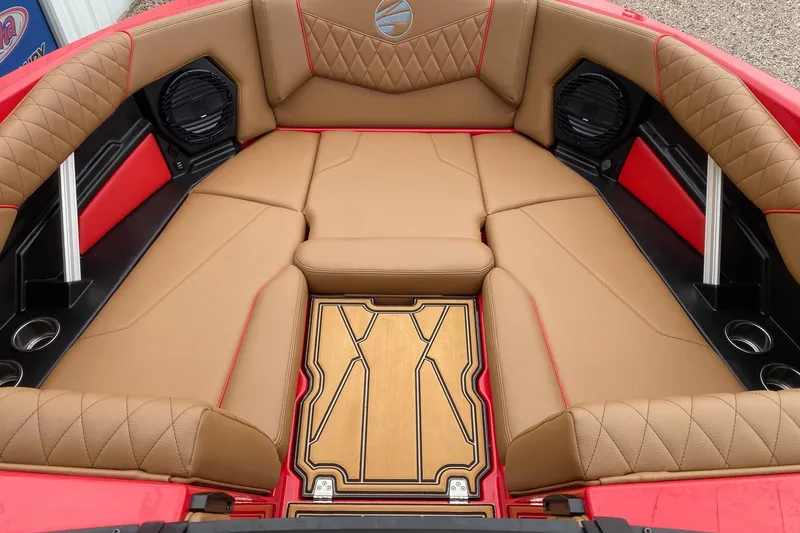 Slide: The Image of 2026 Tigé Z3 boat interior with tan leather seats, red accents, and integrated speakers. - 8