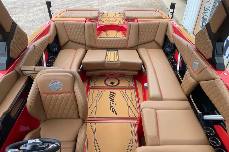 Slide: The Image of Luxurious interior of 2026 Tigé Z3 boat with tan leather seating and red accents. - 9