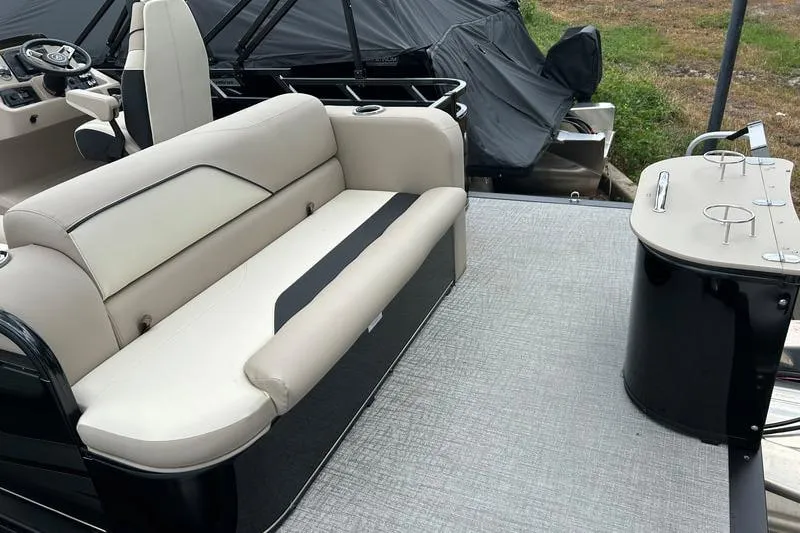 Slide: The Image of 2026 Avalon VENTURE REAR BENCH boat interior with beige seating and cup holders. - 6