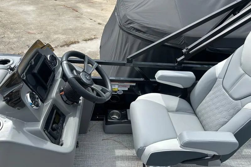 Slide: The Image of 2026 Avalon Venture Fish N Cruise boat interior with steering wheel and comfortable seating. - 5
