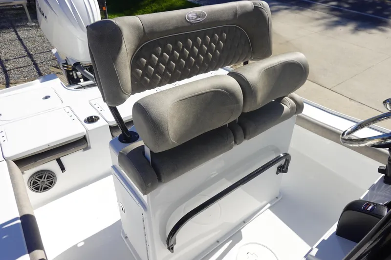 Slide: The Image of 2026 Sea Hunt BX 22 BR boat interior with cushioned seating and steering wheel. - 17