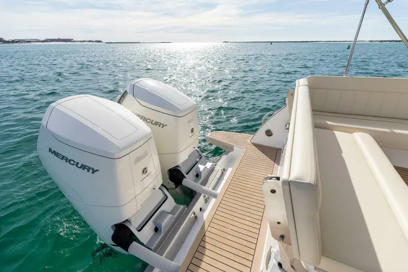 Slide: The Image of 2025 MJM 4 boat with dual Mercury outboard engines on a sunny day. - 38