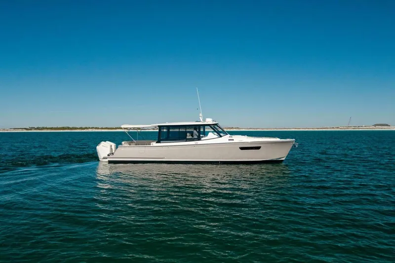 Slide: The Image of 2025 MJM 4 boat cruising on open water under clear blue sky. - 39