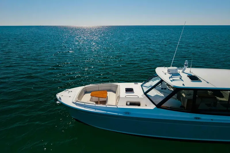 Slide: The Image of 2025 MJM 4 boat cruising on open water, creating a dynamic wake pattern. - 47