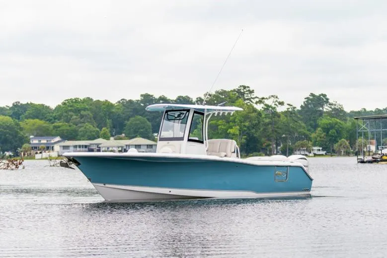 Slide: The Image of 2026 Sea Hunt Ultra 275 SE boat on trailer, parked outdoors under cloudy sky. - 1